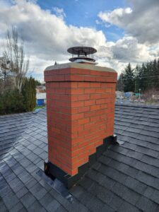 A brick chimney on the roof of a house in Portland.