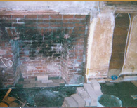 A brick fireplace is being remodeled in a house.