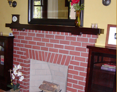 A brick fireplace in a living room.