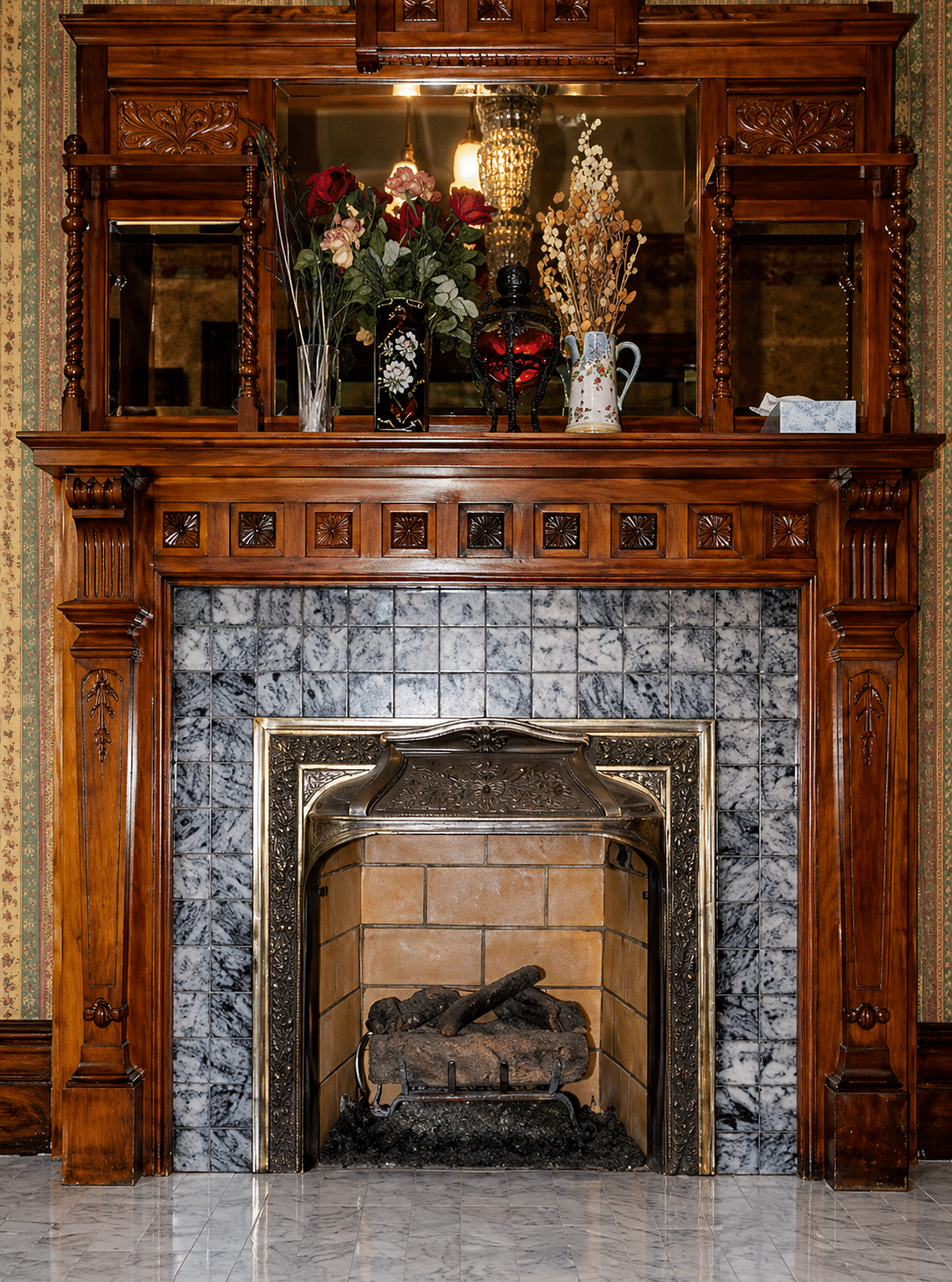 Beautifully restored Victorian fireplace surround with ornate wood mantel, tile hearth, and custom screen — Oregon City historic home.
